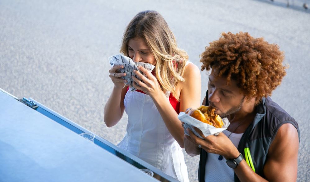 people enjoying fast-food burgers outdoors